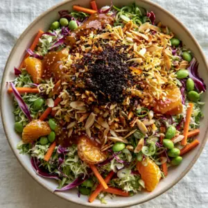 Close up of shredded green and purple cabbage Ramen noodle salad with glossy ginger dressing.