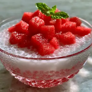 Close up shot of Watermelon Coconut Sago showing translucent sago pearls suspended in opaque white coconut milk.